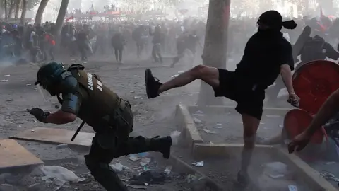 EPA Demonstrators clash with police during a protest in the central Plaza Italia in Santiago, Chile, 12 November 2019.