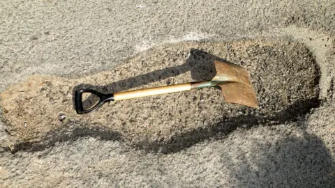 Joseph Hughes Spade in a pothole