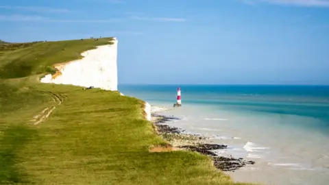 Getty Images Iconic lighthouse and white chalk cliffs at Beachy Head