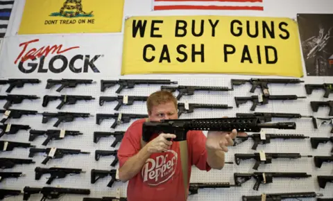 Getty Images Man at gun shop