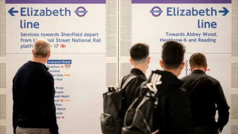 Getty Images Passengers study Elizabeth line route maps