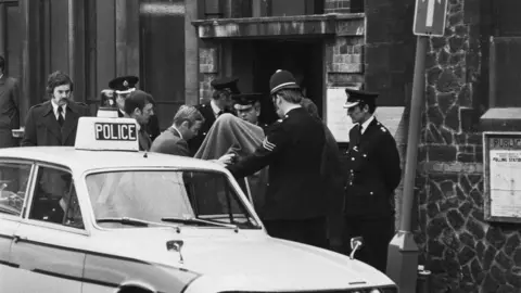 Getty Images Police presence outside the court in Guildford where the Guildford Four first appeared in 1974 before their trial