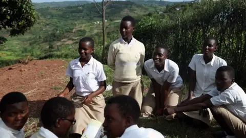 Care Students gather outside the Safe School for Girls to discuss issues facing girls and women in Rwanda