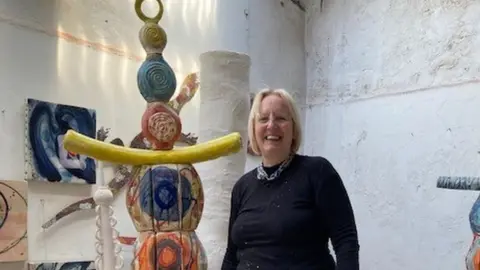 Artist Sandy Brown alongside a prototype of Earth Goddess