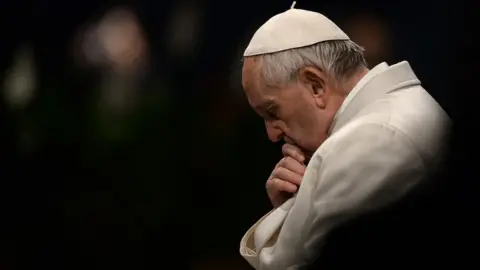 AFP Pope Francis pictured praying as part of Good Friday procession in Rome