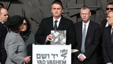 EPA Brazilian President Jair Bolsonaro (C) during a memorial ceremony at the Hall of Remembrance in the Yad Vashem Holocaust memorial museum in Jerusalem, Israel, 02 April 2019.