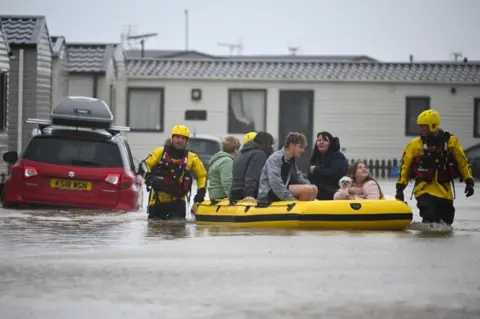 Getty Images People are rescued from their holiday chalets by fire and rescue at Freshwater Beach Holiday Park, on November 02, 2023 in Burton Bradstock, Dorset.