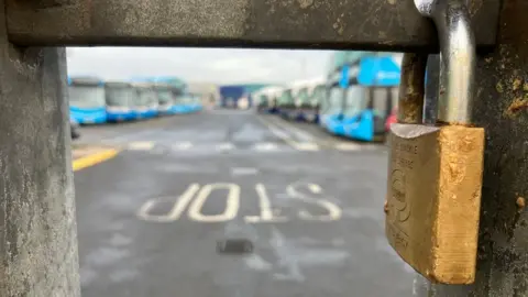 Newry bus depot with padlocked gate in the foreground