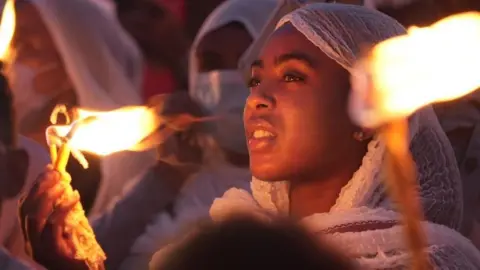 Amensisa Negera/BBC Girl holding a candle