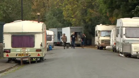 BBC Caravans and vans parked on road