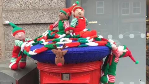 Torphins knitted post box Elves topper in Banchory