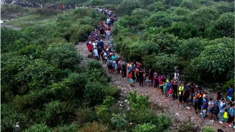 Getty Images Migrants travelling through the Darién Gap between Panama and Colombia