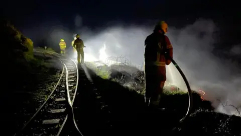 GGR Firefighters by railway line tackling blaze