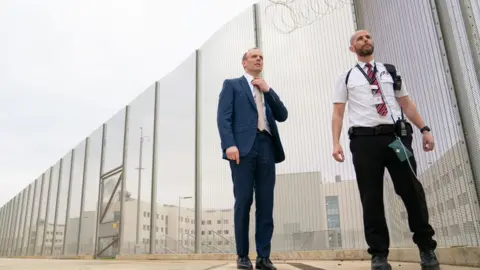 Joe Giddens/PA Wire Deputy Prime Minister and Justice Secretary Dominic Raab with a prison officer at the opening of category C prison HMP Five Wells in Wellingborough