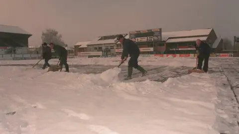 Leicester Tigers Ground staff clear the Welford Road snow