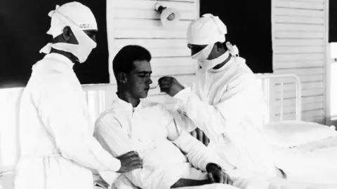 MPI/Getty Images Doctors with a 1918 flu patient at a US naval hospital