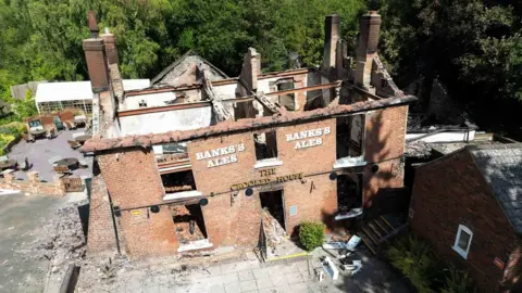 PA Media The remains of the Crooked House pub in the West Midlands