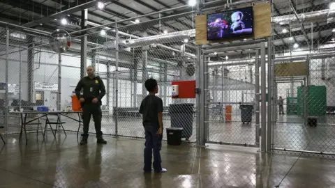 Getty Images A child detainee watches a movie