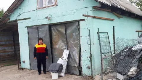 Shelterbox Woman outside house