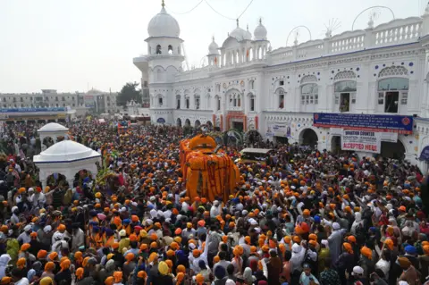 AFP Sikh pilgrims take part in a religious ritual as they gather to celebrate the 550th birth anniversary of Guru Nanak Dev, at Nankana Sahib