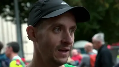 S4C Sion Daniels pictured after the race in Cardiff. He is a young man wearing a black baseball cap