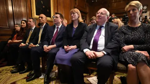 PA The eight former Labour MPs who make up the rest of the Independent Group watch the trio's press conference