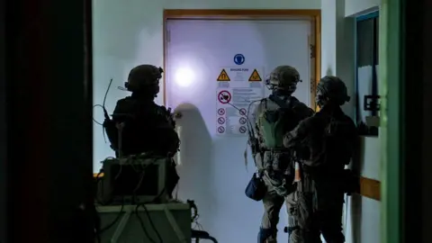 Reuters Israeli soldiers shown inside the Al-Shifa Hospital complex in an Israeli Defense Forces handout image from 15 November 2023