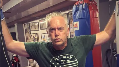 Huw Edwards / Instagram Huw Edwards in front of a boxing bag