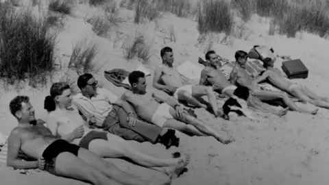 George Walton Soaking up the rays on Bournemouth beach in the 1950s: A group of George's friends enjoying the sun