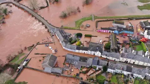 Getty Images Roads and gardens in Crickhowell, Powys, were turned into lakes, after the river burst its banks