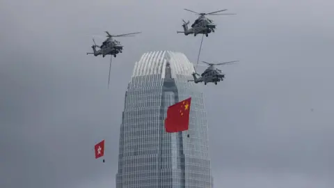 EPA Government Flying Services aircrafts display the People's Republic of China and the Hong Kong SAR flags over the Convention Centre in Hong Kong, China, 01 July 2022