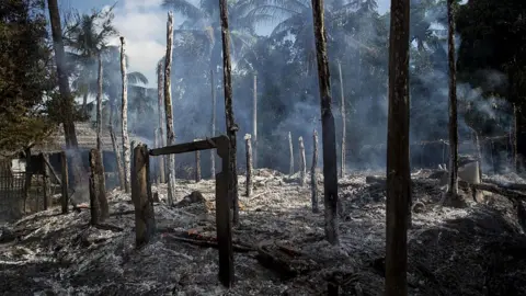 Getty Images Smouldering debris of burned houses is seen in Warpait village, a Muslim village in Maungdaw located in Rakhine State on October 14, 2016