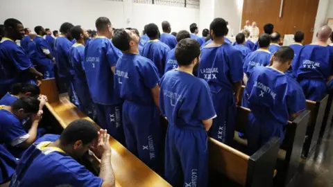 Getty Images Inmates worship during Christmas Mass led by Archbishop Jose H. Gomez in a chapel at Men's Central Jail