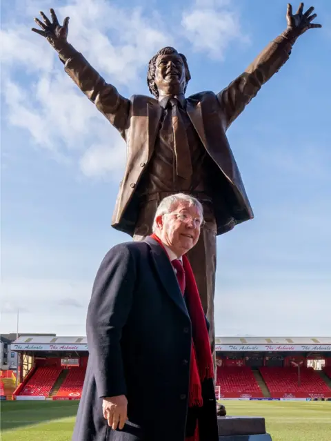 PA Media Sir Alex Ferguson with the statue