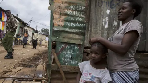 Getty Images Woman with child in Nairobi slum