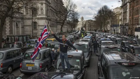 Getty Images Uber drivers stage a protest in central London