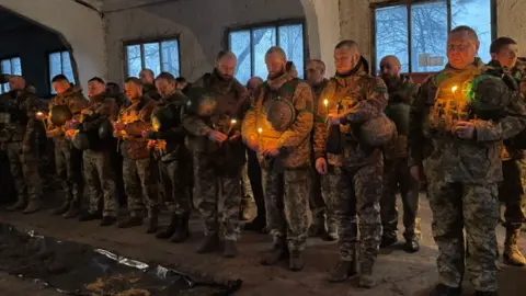 BBC Ukrainian troops hold a Christmas prayer near Kupiansk