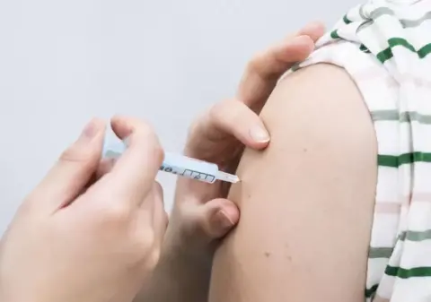 PA Media Close up of someone receiving a vaccine on their arm