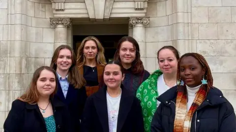 Edward Sutton Representatives from feminist society Stronger Together, Time to Act in front of the university main building