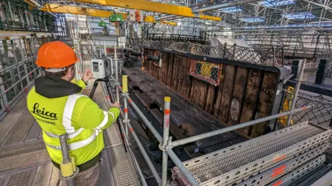 Dr Rodrigo Pacheco-Ruiz Man standing next to tripod