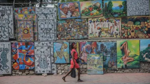 AFP A woman walks in the deserted street in Port-au-Prince on October 18, 2021