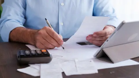 Getty Images Man with calculator
