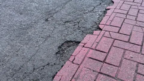 A pothole by a crossing on High Street in Chorley town centre