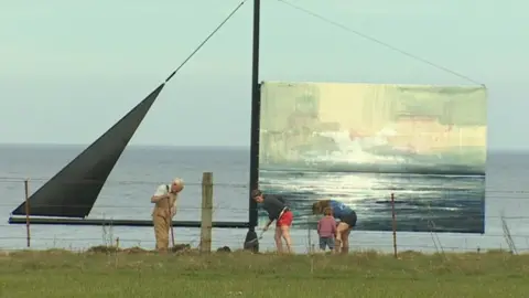 BBC artwork on cliff