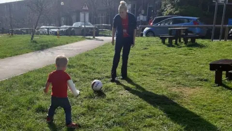 Vicky Flintoft Archie practising his football skills outside Leeds Royal Infirmary