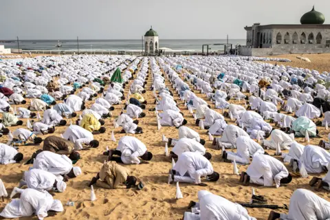 John Wessels / AFP Followers of the Senegalese Layene community perform a prayer during Tabaski celebrations in Dakar on 21 July 2021