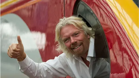 Corbis Richard Branson sticks his head out of a Virgin train window