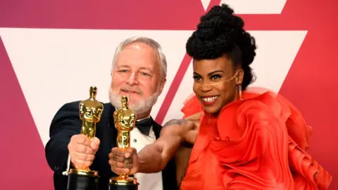 Getty Images Jay Hart and Hannah Beachler, winners of Best Production Design for 'Black Panther,' pose in the press room during the 91st Annual Academy Awards at Hollywood