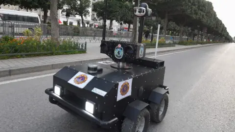 AFP A Tunisian police robot patrols along Avenue Habib Bourguiba in the centre of the capital Tunis on 1 April 2020