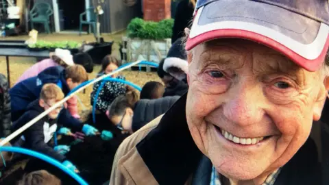 John Devine/BBC Don Bradshaw in a red cap smiling